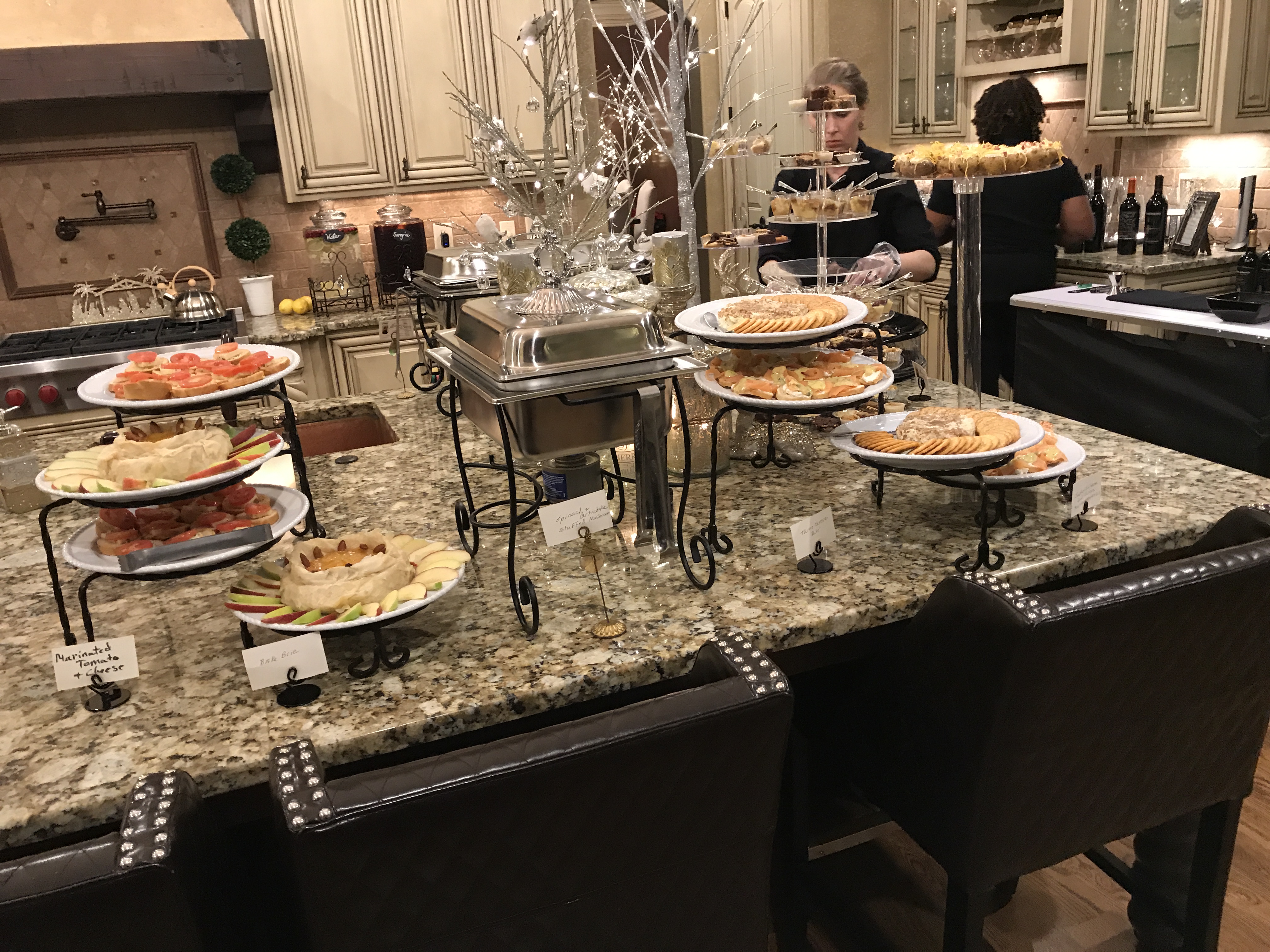 Fundraiser spread of baked brie, marinated tomatoes, smoked salmon, and three-cheese pâté