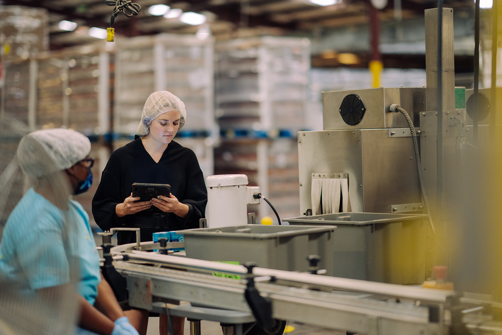 Supervisor and worker in discussion on the co-packing floor at TEKPAK's Marion, AL facility
