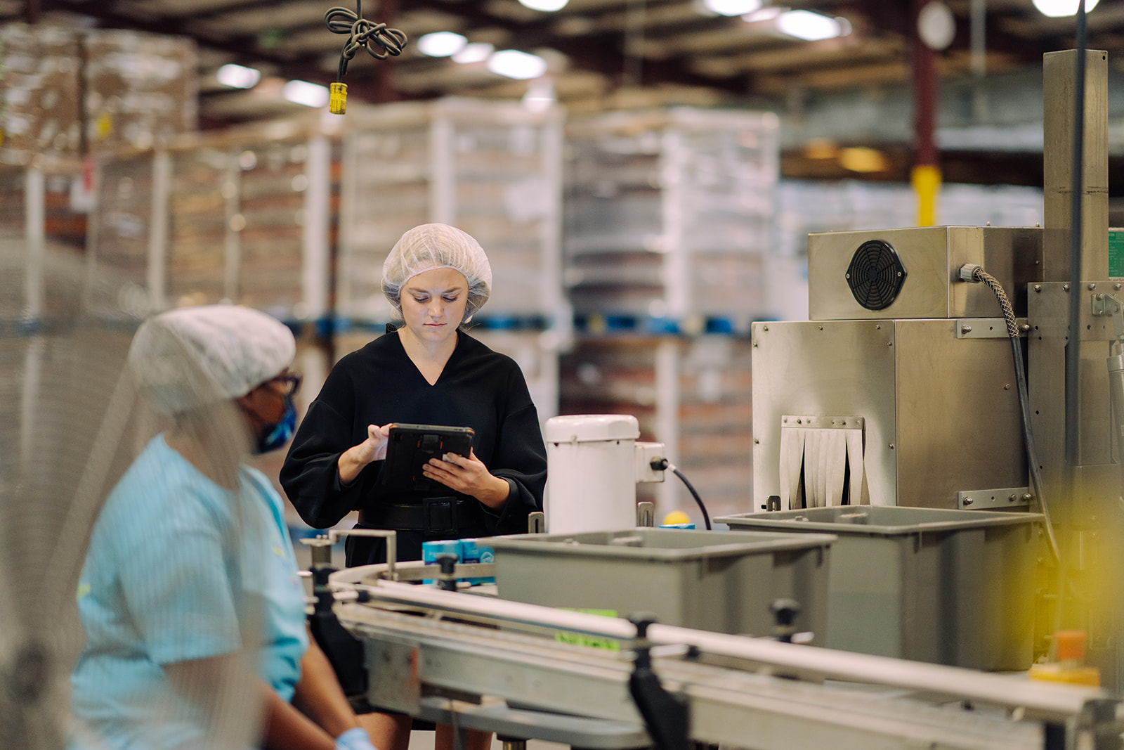 A production supervisor walking the co-packing floor at TEKPAK's Marion, AL facility