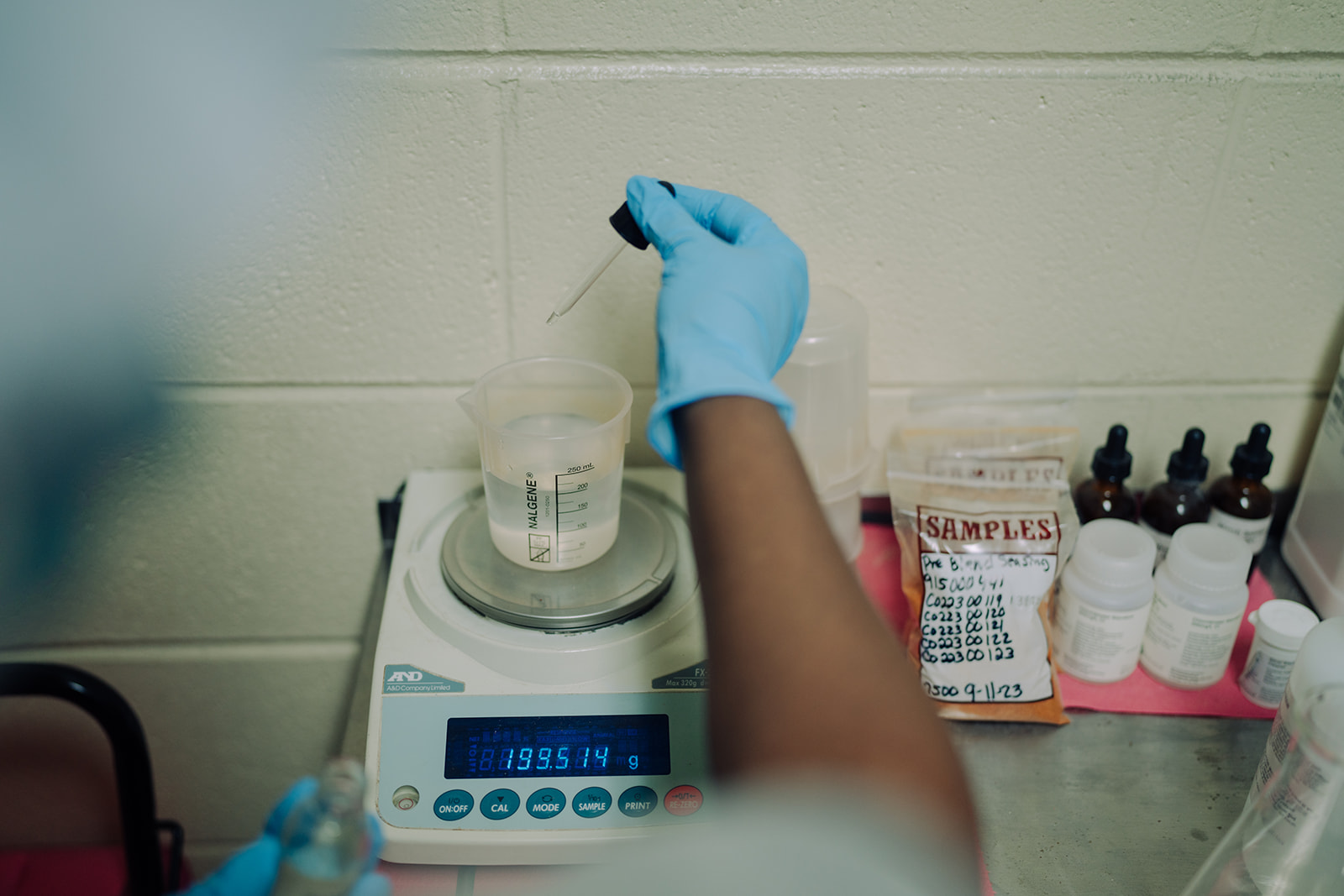 A technician performing a quality-control test on a product sample at TEKPAK's Marion, AL facility