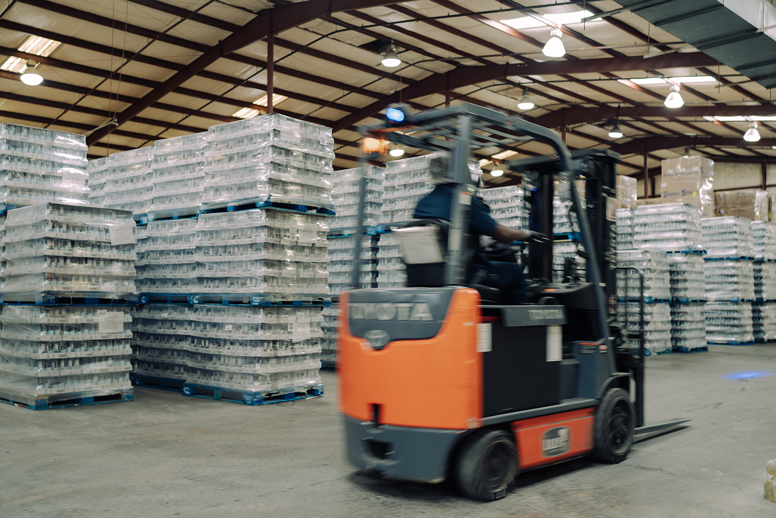 A forklift moving inventory in the warehouse at TEKPAK's Marion, AL facility