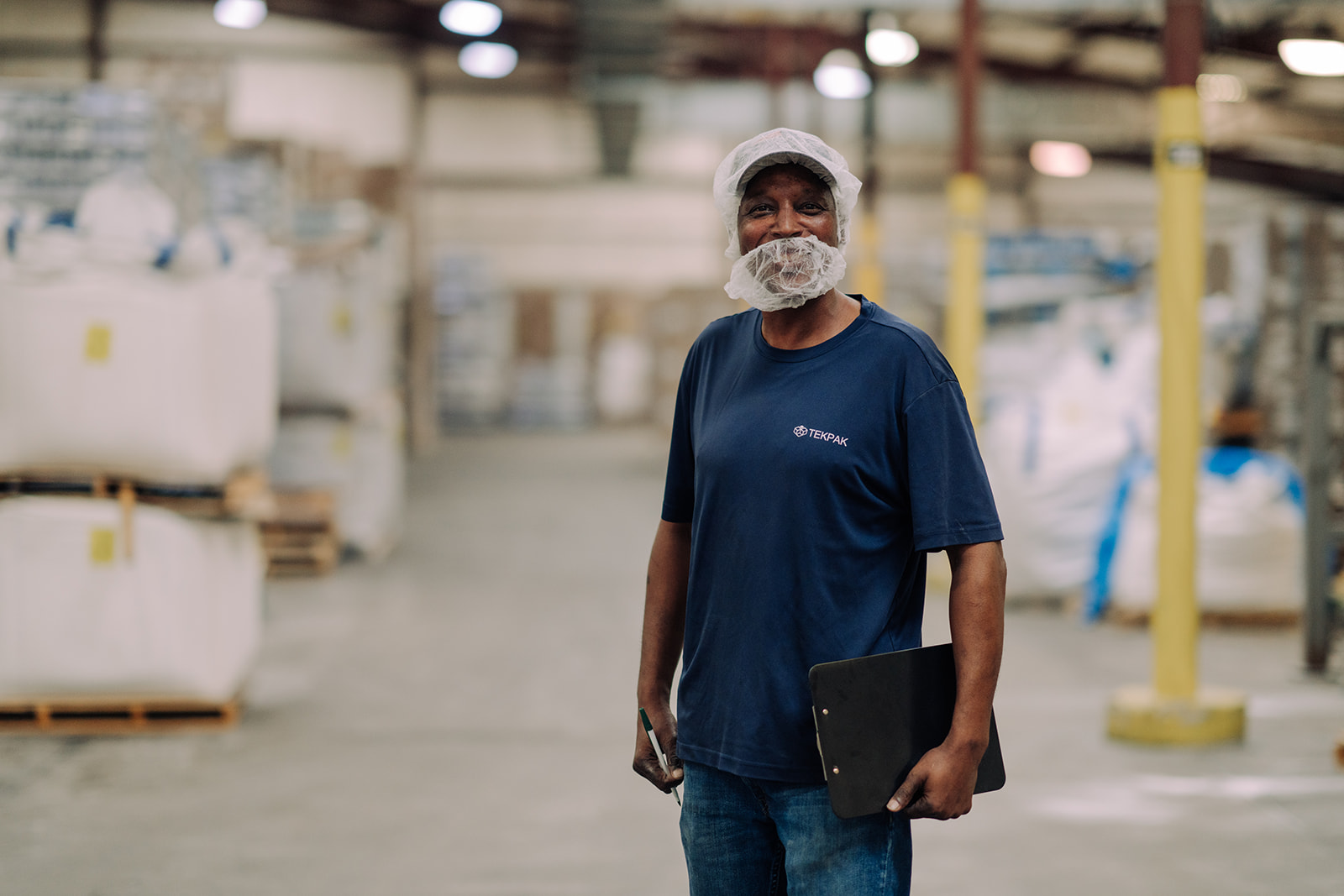 Worker portrait in warehouse setting at TEKPAK's Marion, AL facility