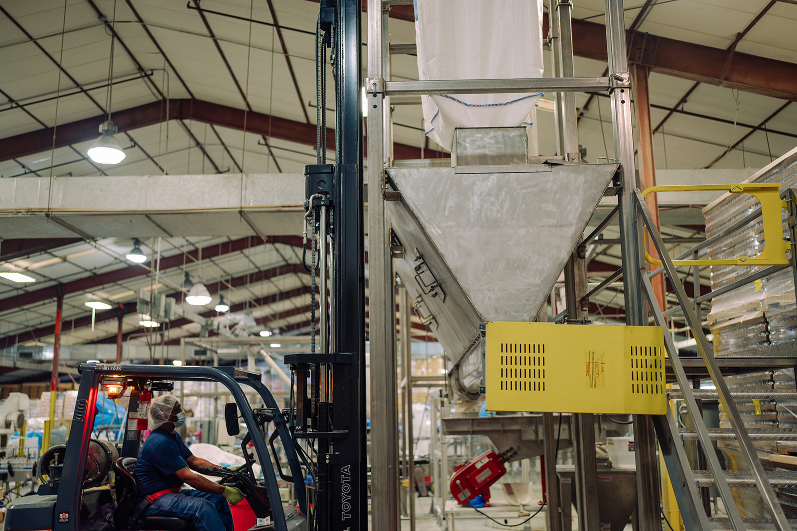 Multiple workers collaborating on the co-packing floor at TEKPAK's Marion, AL facility