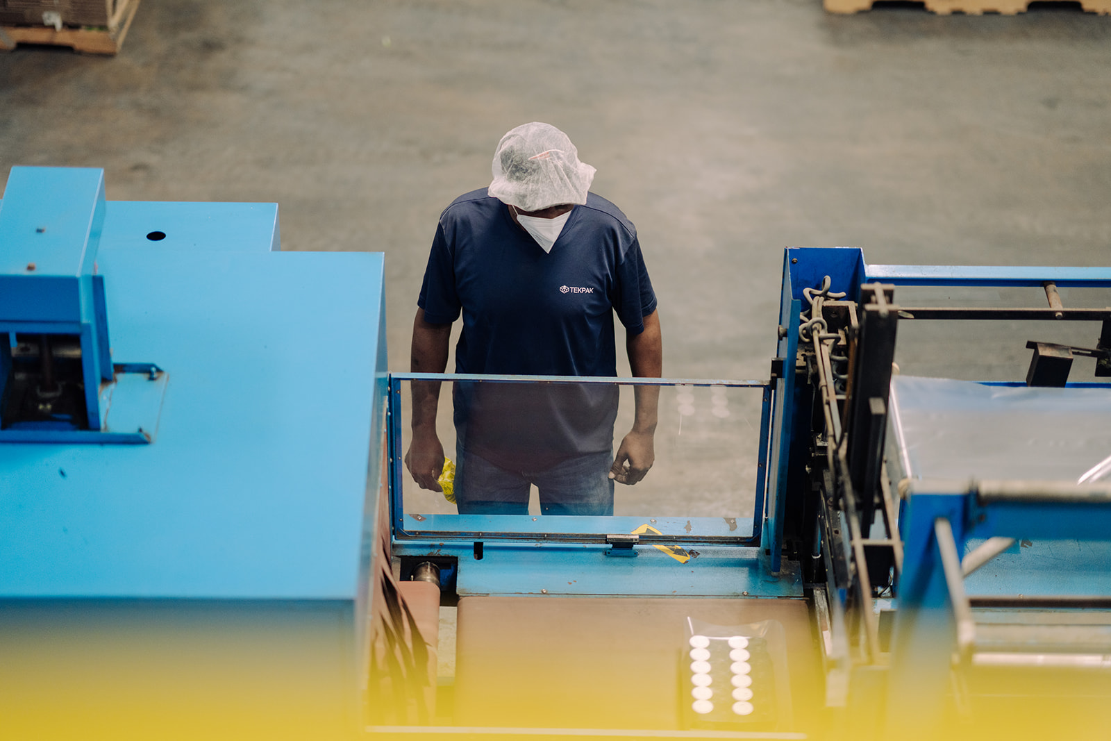Two team members coordinating on the line at TEKPAK's Marion, AL facility